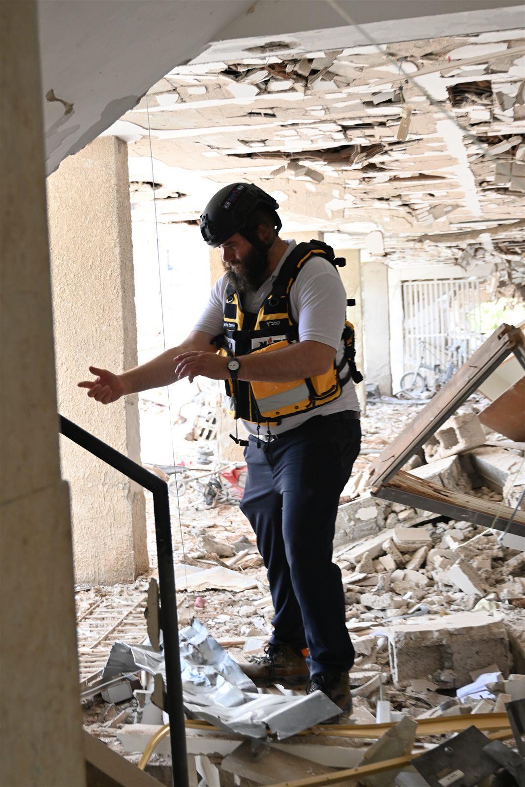 A ZAKA volunteer directing the search amid the rubble