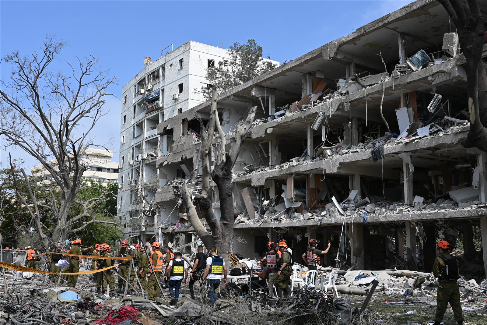 Collapsed building with rescue teams searching the rubble