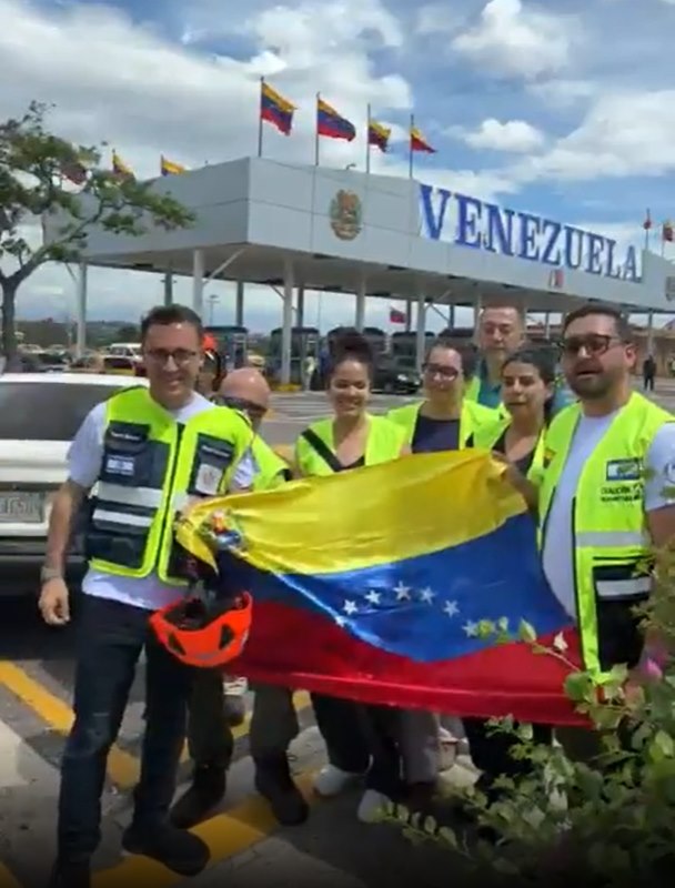 ZAKA volunteers with the Israeli and Venezuelan flags on arrival in Venezuela